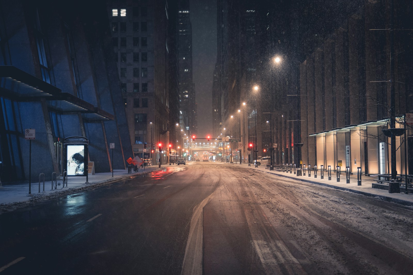 City street at night with falling snow