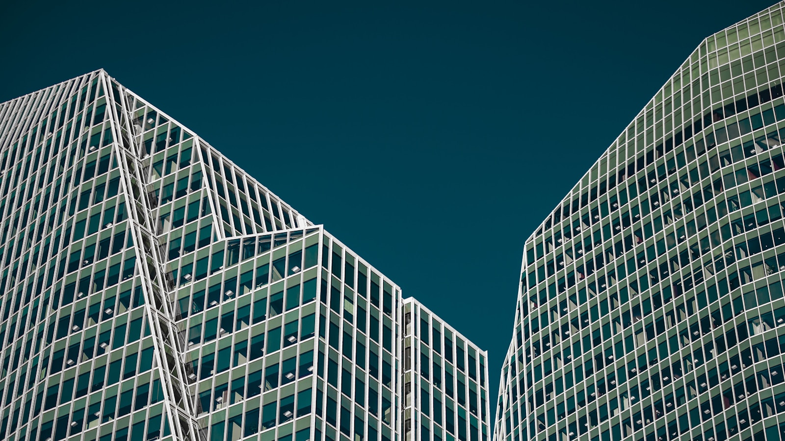 Modern buildings against a dark teal sky.
