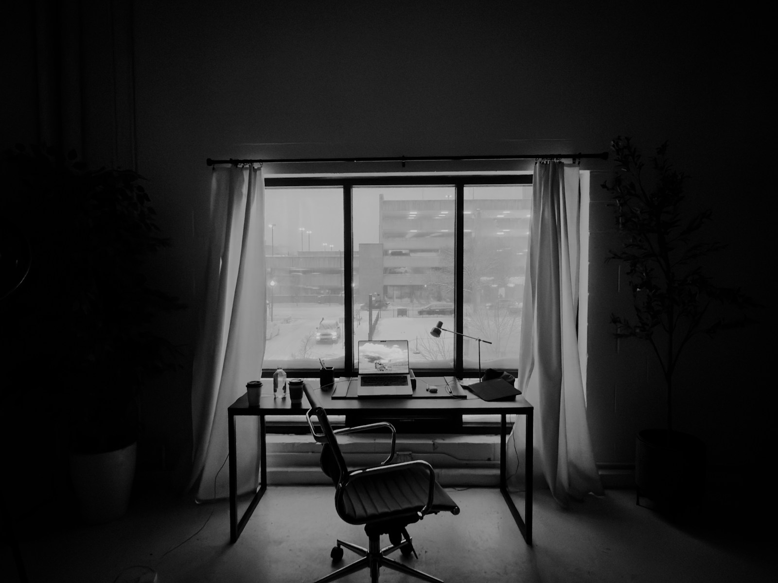 An empty office desk in front of a window.