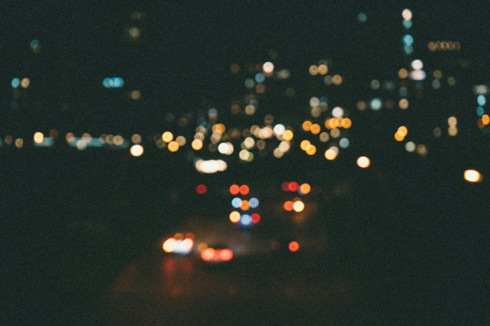 Blurred city lights and car trails at night